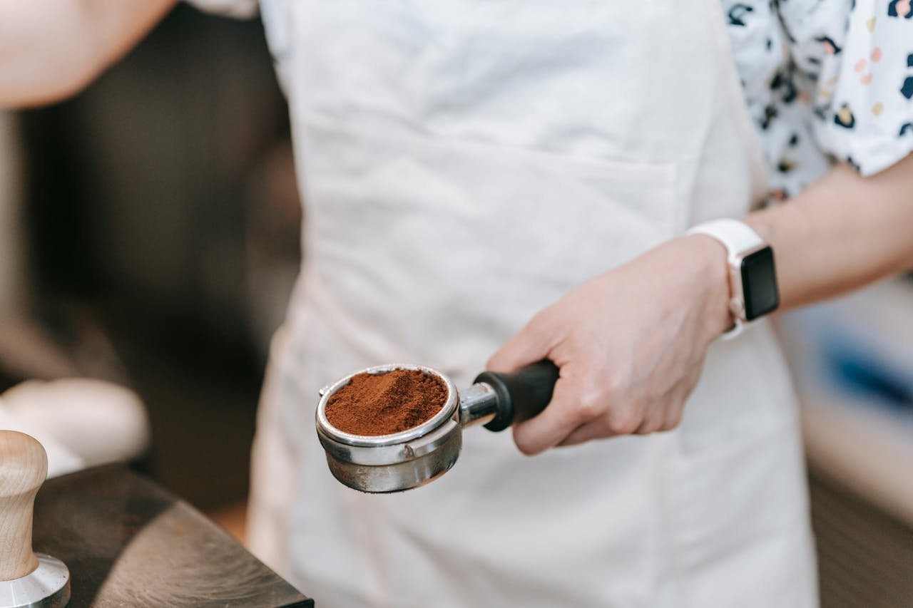 pexels-photo-9050554 A Barista Holding a Portafilter